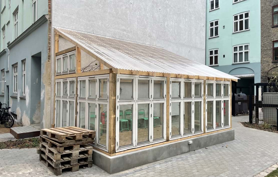 Kasserede vinduesrammer fra opsætning af altaner indgår i det nye bæredygtige orangeri.